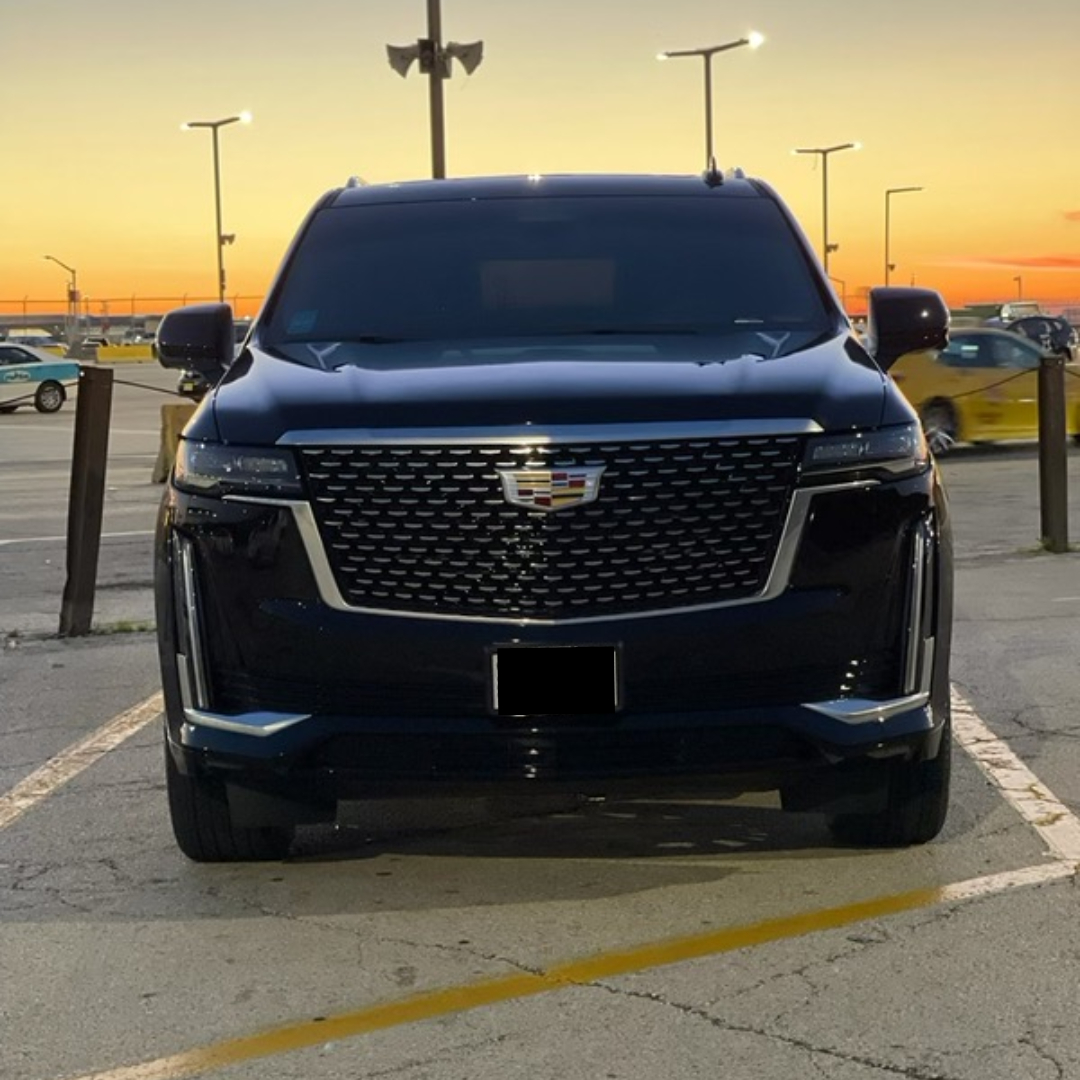 A black luxury SUV standing in the parking lot side of a road